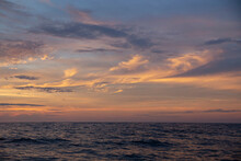 Sunset With Pastel Colored Clouds In The Ocean