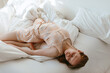 © Sergey Filimonov/Stocksy - Woman in sleepwear lying on bed