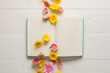 © Kristin Duvall/Stocksy - Flowers in open book