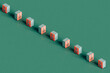 © Giada Canu/Stocksy - a row of Close pink Safe box on green background