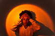 © Mauro Grigollo/Stocksy - Woman in orange light