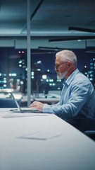 Poster - Vertical Screen: Successful Businessman Working on Laptop Computer in Office Late in the Evening. Investment Analyst Checking Financial Management Reports, Drinking Water from Glass. Static Shot.