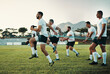 © Allistair F/peopleimages.com - They take their training sessions very seriously. Full length shot of a group of young rugby players training with bands on the field during the day.