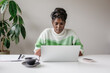 © Jodie Johnson Photography/Stocksy - Portrait of a confident business woman working at a desk