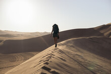 Woman Walking In Desert
