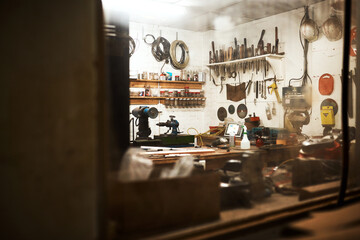 Wall Mural - This is my workshop. Shot of a workshop filled with different types of tools inside someones home at night.