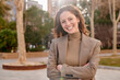 © Ivan Gener/Stocksy - Smiling young businesswoman standing outdoors