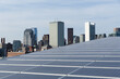 © Raymond Forbes LLC/Stocksy - Solor Panels in city urban Downtown Boston Skyline Environment