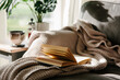 © Helen Rushbrook/Stocksy - Book on sofa