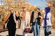 © VICTOR TORRES/Stocksy - Cheerful Muslim women in hijab having a walk and talking to each other
