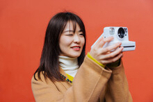 Woman Using An Instant Camera