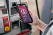 © Sean Locke/Stocksy - Woman Uses Smart Phone To Pay For Gas