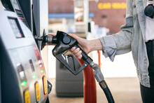 Woman Takes Nozzle Handle At Gas Pump