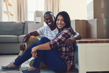 Aufkleber - We finally own one of our dreams. Portrait of a young couple taking a break while moving house.