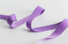Falling Spiral Purple Ribbon Close-up. Structural Purple Ribbon. Decorative Ribbon.