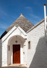 Wall Mural - Trulli village in Alberobello, Italy. The style of construction is specific to the Murge area of the Italian region of Apulia (in Italian Puglia). Made of limestone and keystone.