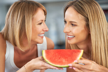 Wall Mural - Nice two adult girls in the kitchen with watermelon