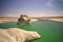 An Aerial View Of Lone Rock In Lake Powell, Blue Cloudy Skies And Green Water. Arizona USA