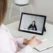 © golubovy - Video call. Online meeting. Corporate telecommuting. Female business partners discussing project working using tablet screen in digital office.