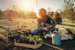 © cherryandbees - woman enjoying time in her backyard planting vegetables and herbs