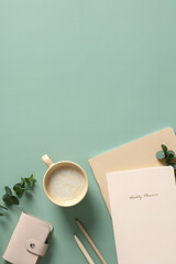 Canvas Print - Aesthetics workspace with cup of coffee, paper notebooks, feminine accessories and eucalyptus leaves on green table. Flat lay, top view.