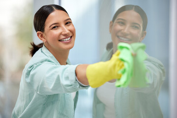 Canvas Print - Put your back into it. Shot of a beautiful young woman cleaning her home windows.