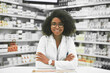 Whats on the menu today. Portrait of a cheerful young female pharmacist standing with arms folded while looking at the camera in a pharmacy.