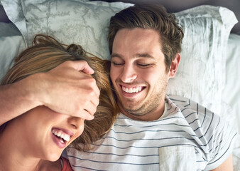 Poster - Never stop making memories. Shot of a young man playfully covering his girlfriends eyes while lying in bed.