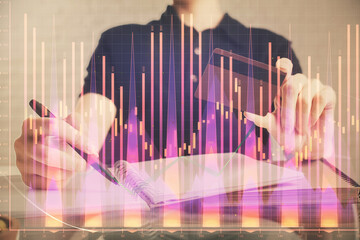 Double exposure of man hands holding a credit card and Forex graph drawing. Stock trading and digital fintech in Internet E-commerce concept.