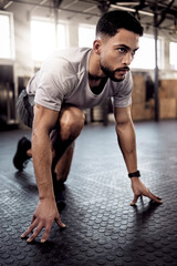 Poster - Theres no secret formula. Shot of a sporty young man stretching his legs while exercising in a gym.