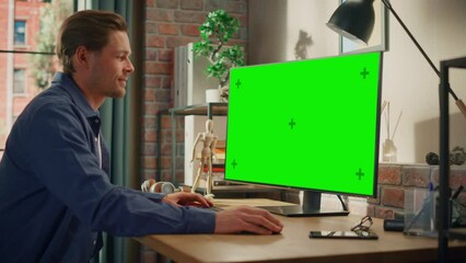 Aufkleber - Young Handsome Man Working from Home on Desktop Computer with Green Screen Mock Up Display. Male Checking Corporate Accounts, Messaging Colleagues. Loft Living Room with Big Window. Handheld Shot.