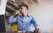 © BullRun - Handsome Caucasian man drinking tasty caffeine beverage during laptop remote working at table desktop, smart casual freelancer dressed in blue shirt enjoying coffee break during distance job
