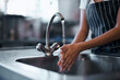 © Nicholas Felix/peopleimages.com - Good food starts with good hygiene. Cropped shot of a woman washing her hands in the sink of a commercial kitchen.