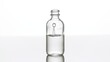 Drop of hyaluronic acid falls down into medical bottle with grey transparent liquid making column splash inside it on white background | Abstract cosmetics formulating concept