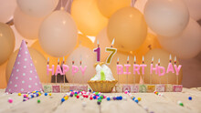 Beautiful Background Happy Birthday Number 17 With Burning Candles, Birthday Candles Pink Letters For Seventeen Years Old. Festive Background With Balloons