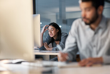 Aufkleber - Over tiredness leads to underperformance. Shot of a young woman feeling stressed while using a headset and computer late at night in a modern office.