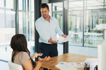 Wall Mural - You call this a sales report. Shot of an angry businessman confronting his colleague about paperwork in the office.