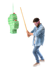 Canvas Print - Handsome man breaking Mexican pinata on white background