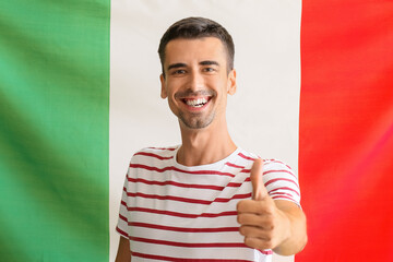 Canvas Print - Handsome young man showing thumb-up against Italian flag