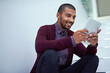 © Mikolette Moller/peopleimages.com - Technology is always at his side. Cropped shot of a young businessman using a digital tablet on the stairs in a modern office.