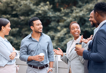 I couldnt believe she said that. Shot of a group of businesspeople outside having coffee and conversation.