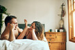 © Tamani Chithambo/peopleimages.com - Love is the easiest way to have a sweet day. Shot of an affectionate young couple spending a romantic morning in bed at home.