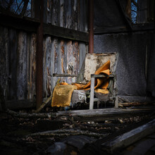 Old Ruined Armchair With Orange Foam In A Dilapidated Wooden Hut