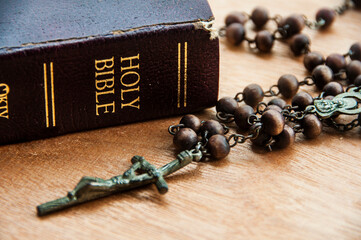 Wall Mural - Close up of Holy Rosary with Bible on wooden table. Religious concept