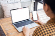 © panitan - computer screen,cell phone blank mockup.hand woman work using laptop texting mobile.white background for advertising,contact business search information on desk in cafe.marketing,design