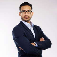 A successful entrepreneur believes in his abilities. Studio portrait of a confident young businessman standing with his arms crossed against a white background.