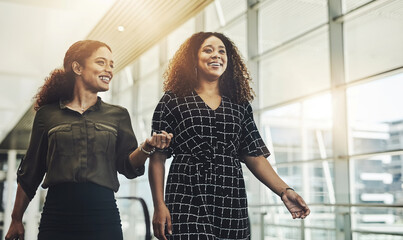 Aufkleber - Smile your way to the top. Cropped shot of two attractive young businesswomen walking through a modern workplace.