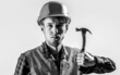 © Yevhen - Handyman services. industry, technology, builder man, concept. Man worker, building helmet, hard hat. Hammer hammering. Builder in helmet, hammer