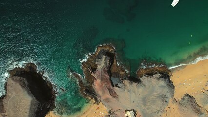 Wall Mural - Aerial shot of sandy beach of Lanzarote. People relax on most popular Papagayo beach of Lanzarote, cove of white sand, Atlantic Ocean bay, crystal clear, green water. Travel destinations. Spain