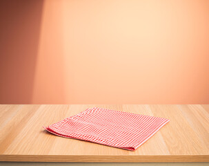 Wall Mural - Red fabric,cloth on wood table top on color wall background.